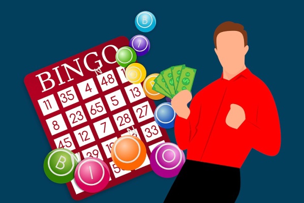 man holding money in front of bingo cards